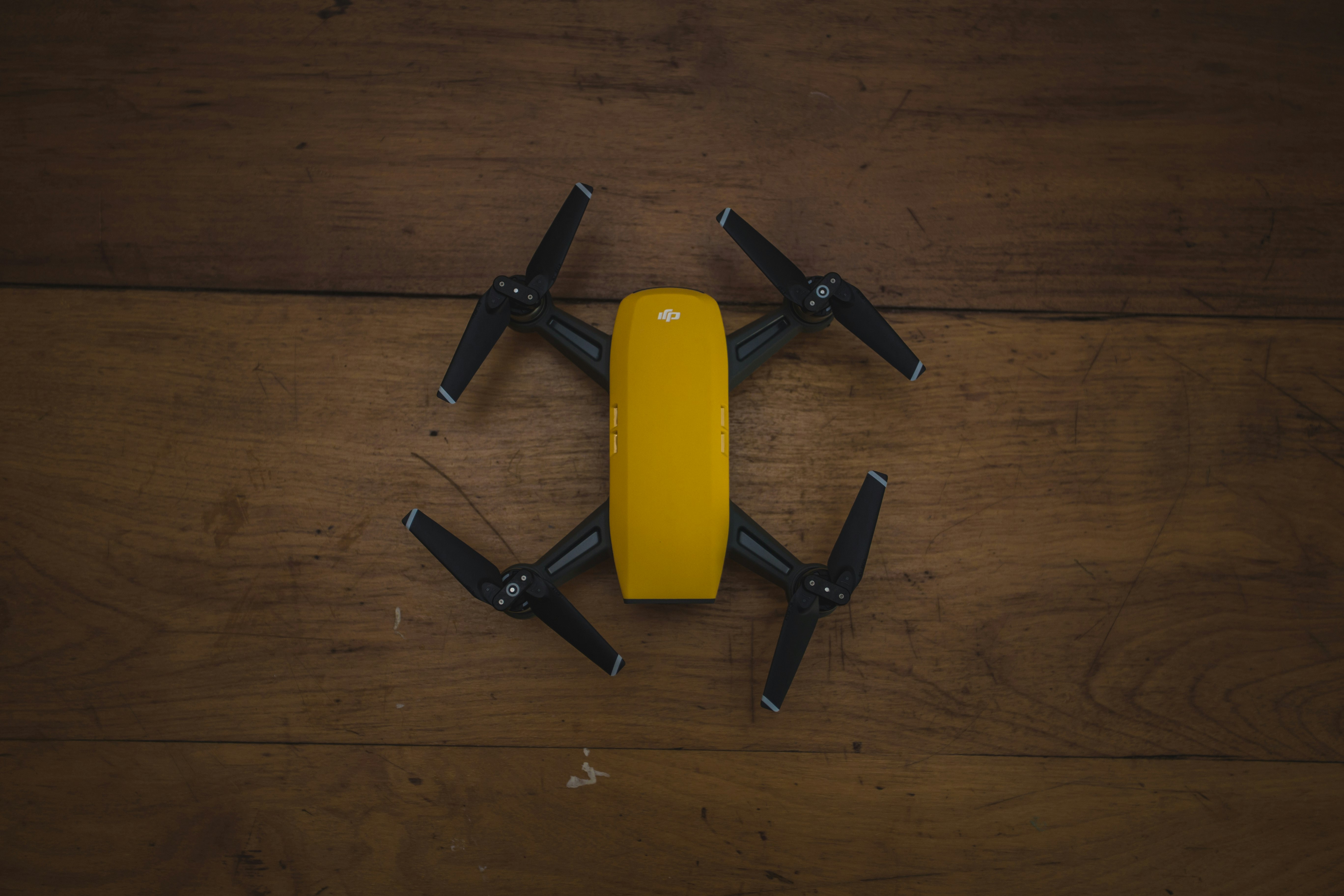yellow and black drone on wooden surface